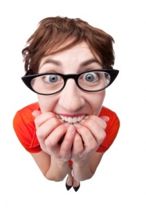 A fisheye image of a an anxious nerd biting her nails.