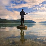 man_fishing_in_middle_of_lake